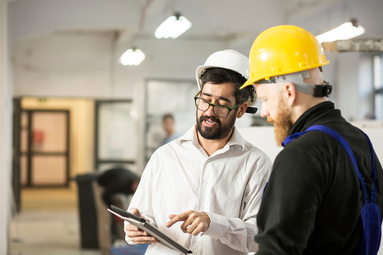 Field service professionals managing tasks and schedules using a tablet device.