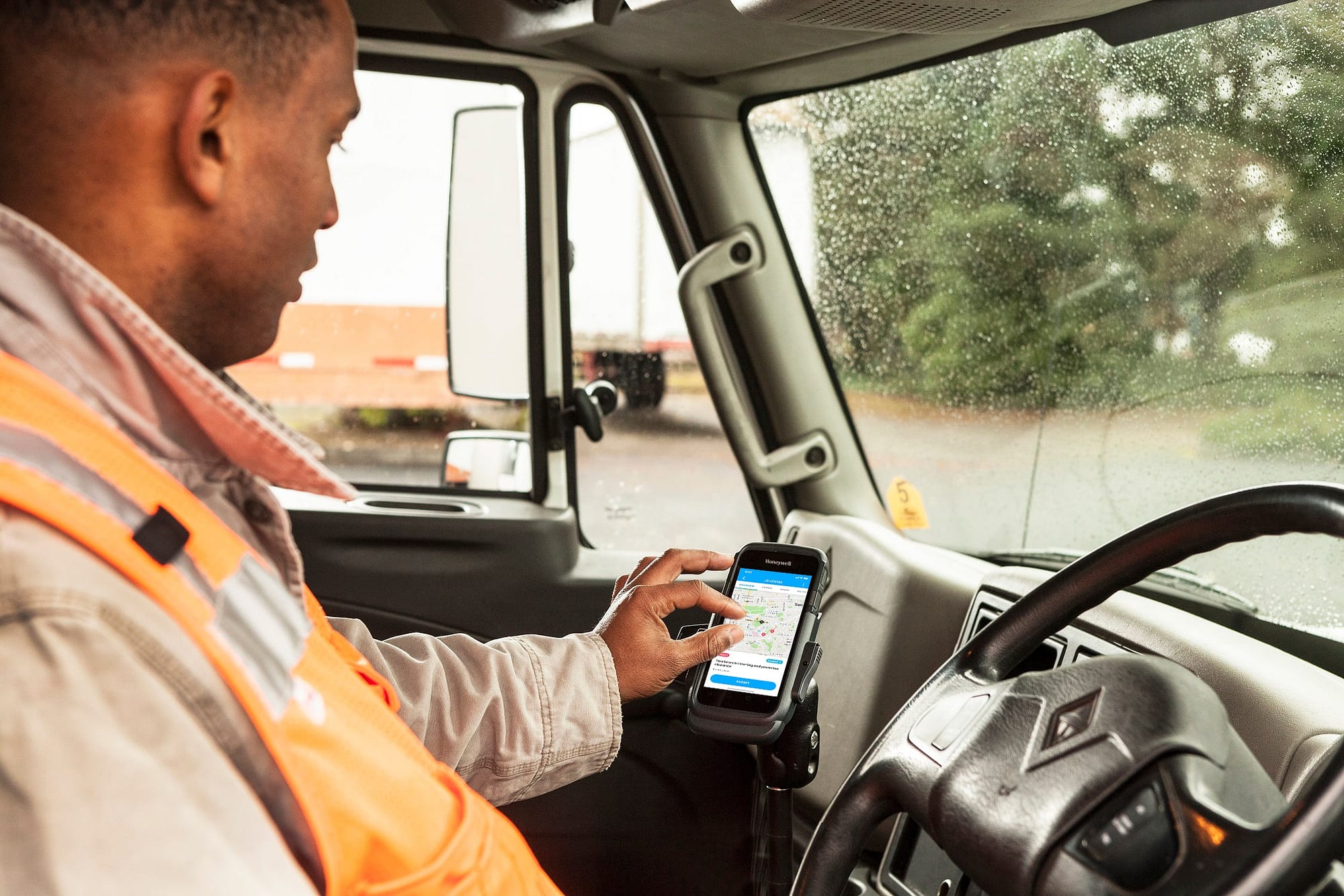 field service man in truck using fleet tracking app